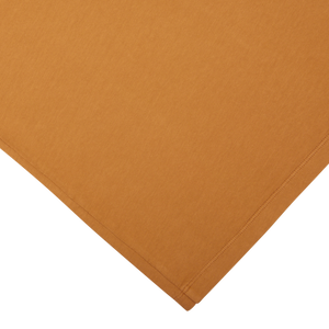 Folded Brick Orange Heavy Organic Cotton T-Shirt fabric from Tela Genova on a white background.
