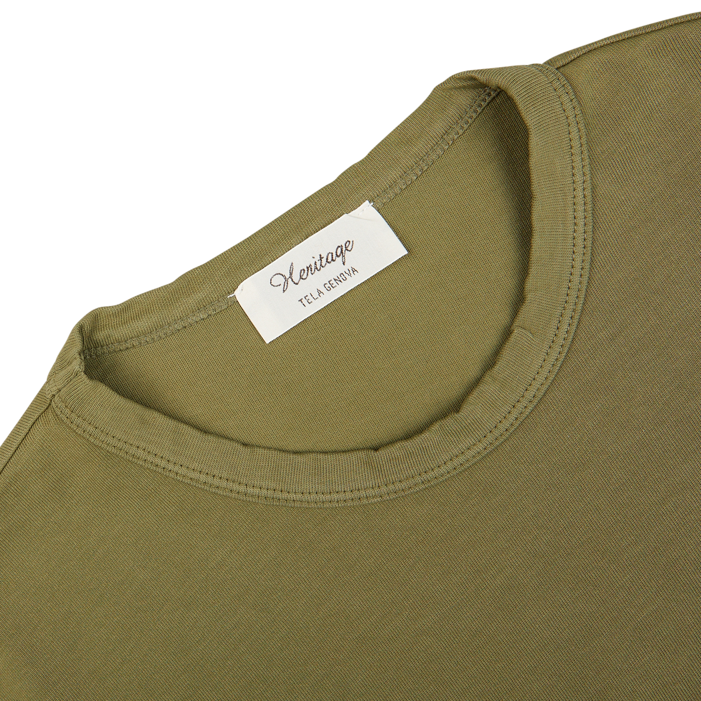 Close-up of a Tela Genova green Heavy Organic Cotton T-Shirt's collar with a white clothing label.