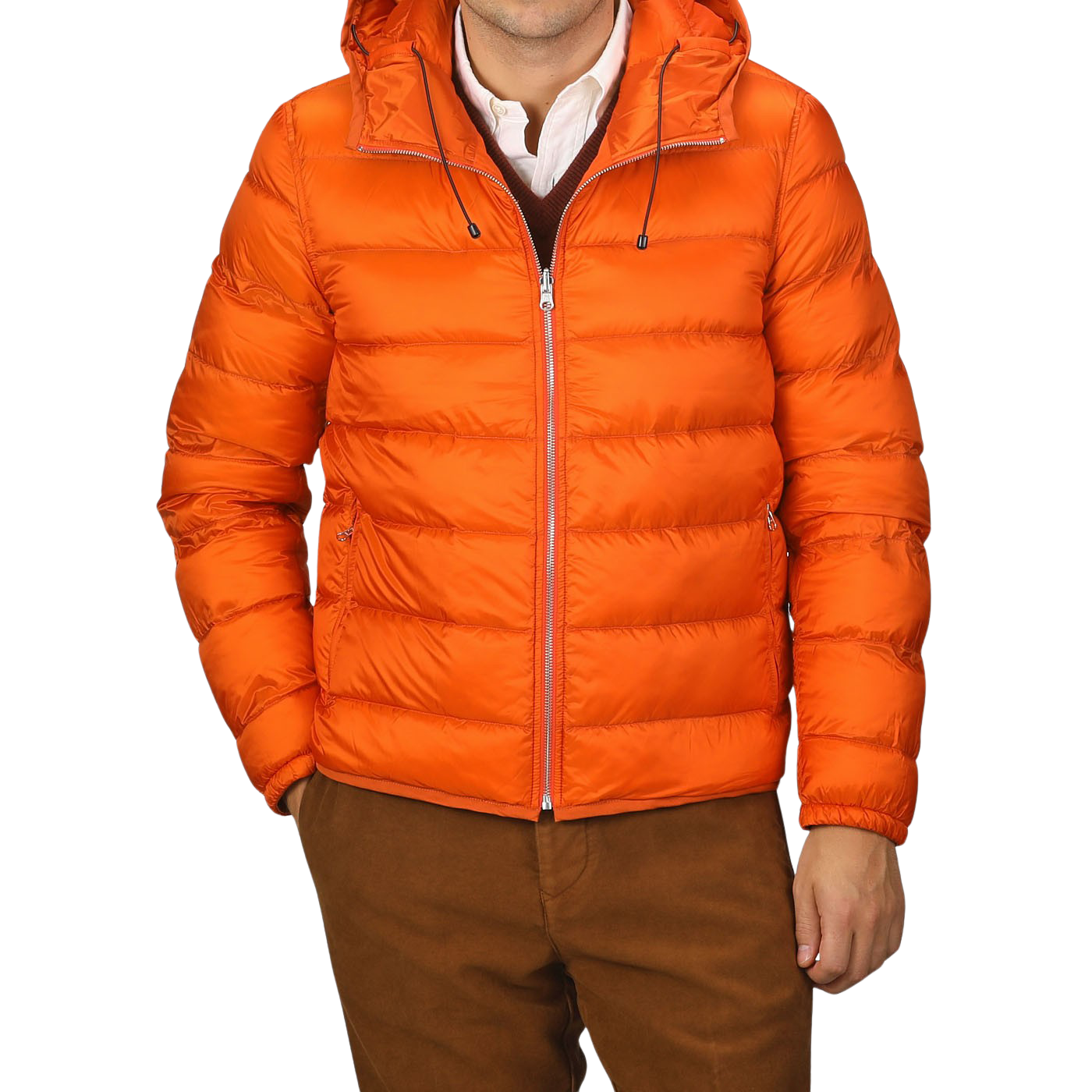 A person wearing an Orange Nylon Down Padded Liner Hood Jacket by Ten C over a white collared shirt and maroon sweater, paired with brown pants.