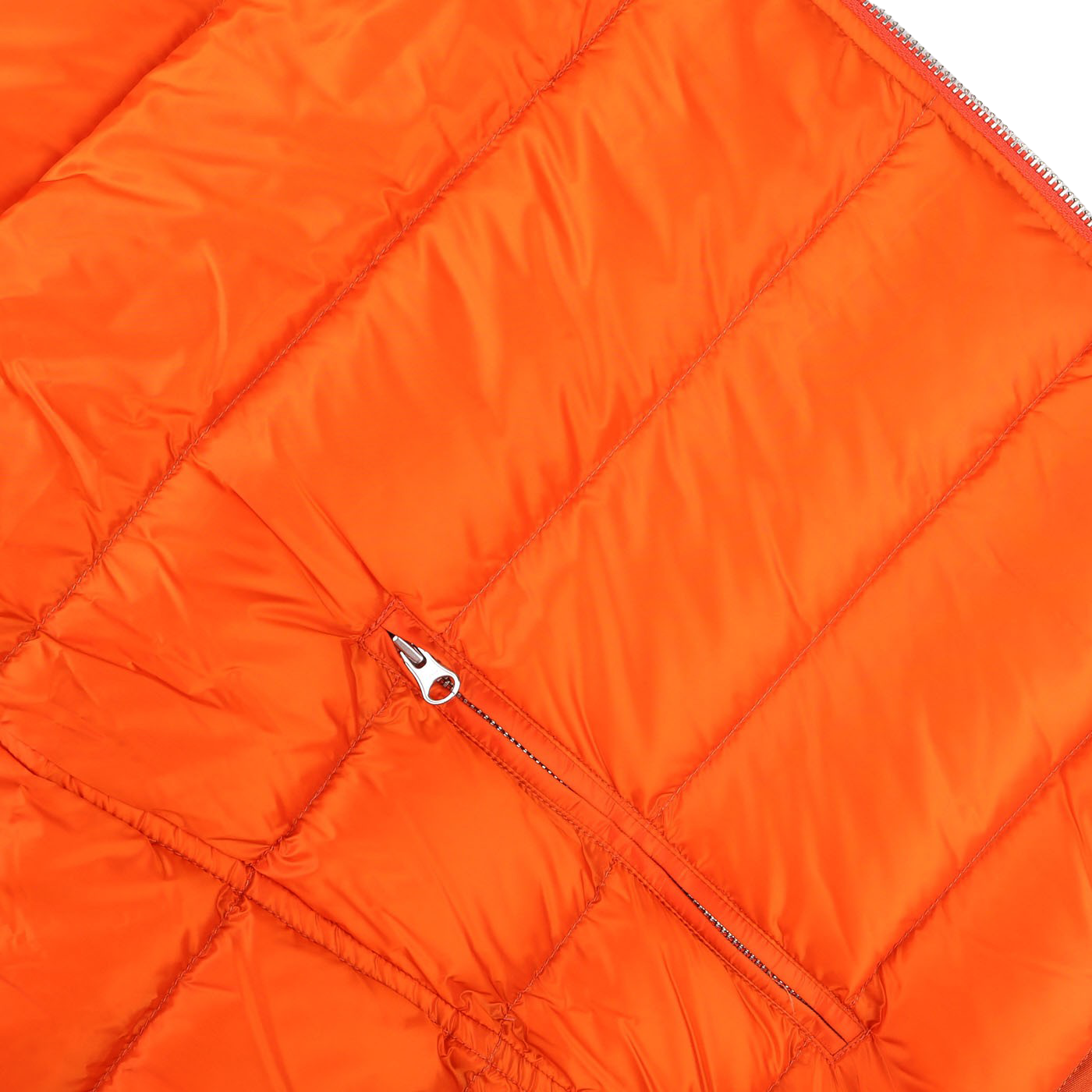 Close-up of the Orange Nylon Down Padded Liner Hood Jacket by Ten C, featuring quilted fabric with a horizontal zipper on one of the sections, showcasing technical outer nylon ideal for a down liner jacket.