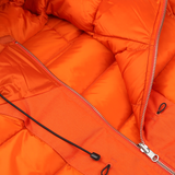 Close-up of the Ten C Orange Nylon Down Padded Liner Hood Jacket, showcasing its open zipper and hanging drawstring cords. The detailed stitching, quilted pattern, and technical outer nylon material are clearly visible.