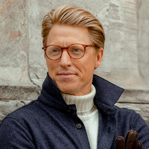 A man wearing The Bespoke Dudes Cran Matte Classic Tortoise Optical 49mm glasses and a sweater.