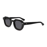A pair of Juta Eco Black Grey Lenses 46mm sunglasses by The Bespoke Dudes, with a classic square frame design, displayed against a solid black background.