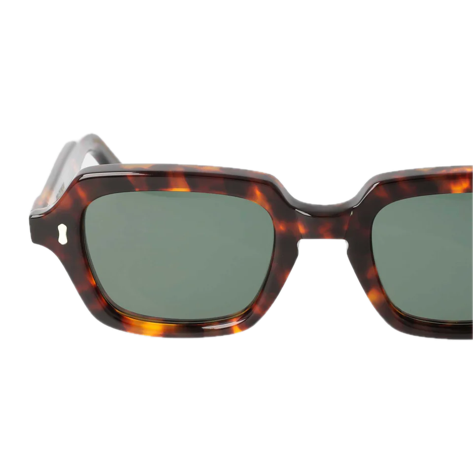 A pair of Oak Eco Spotted Havana sunglasses with dark green lenses, isolated on a transparent background by The Bespoke Dudes.