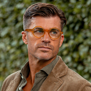 A man wearing glasses and The Bespoke Dudes Oxford Honey Optical 46mm acetate sunglasses.