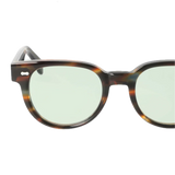 A pair of handcrafted Palm River Light Green Sunglasses 51mm with round lenses and a translucent bottom, isolated on a white background by The Bespoke Dudes.