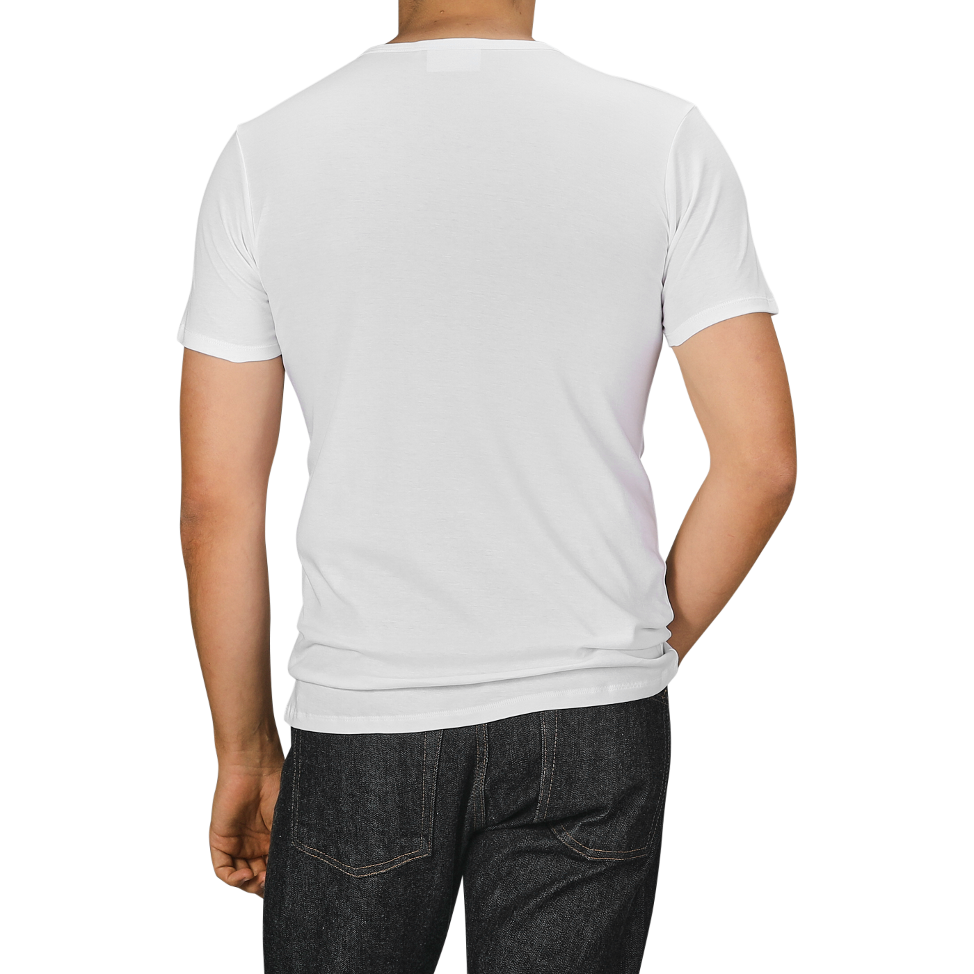 A person wearing The White Briefs' White Pima Cotton Earth T-Shirt and dark jeans is shown from the back against a neutral background.