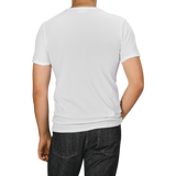 A person wearing The White Briefs' White Pima Cotton Earth T-Shirt and dark jeans is shown from the back against a neutral background.