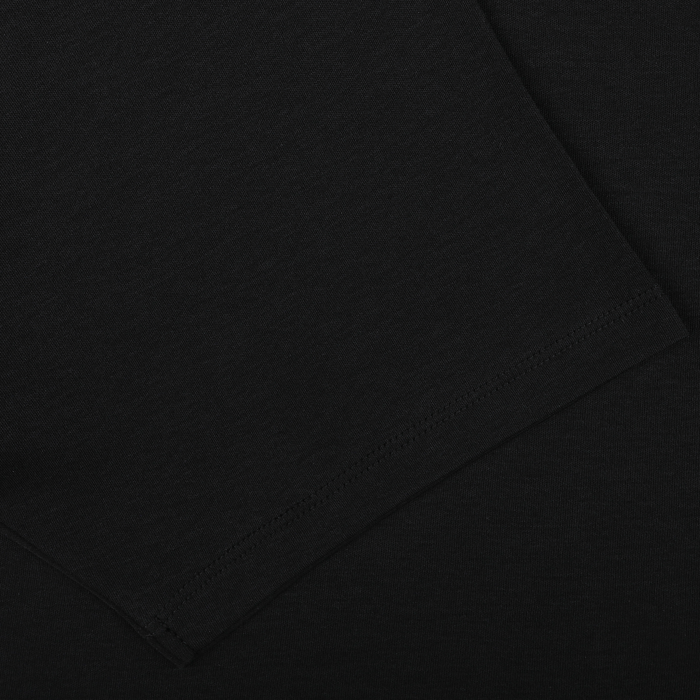 Close-up image of the black sleeve of a slim fit Black Pima Cotton Earth T-Shirt by The White Briefs, highlighting the fabric texture and stitching details.