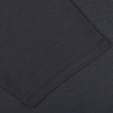 Close-up view of the dark gray fabric with visible stitching along the edge, perfect for The White Briefs' Parisian Night Pima Cotton Earth T-Shirt.