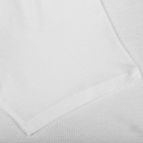 A White Pima Cotton Earth T-Shirt by The White Briefs, known for its white slim fit and made from organic pima cotton, lies on a pristine white surface.