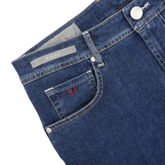 Discover style and comfort with Tramarossa's Blue Sky Relax Super Stretch Michelangelo Jeans. These slim-fit blue denim jeans have a front pocket, red "OJ" stitched initials, and feature a "R-ELAX" label and button closure on the waistband.