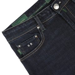 Close-up of the waistband and front pocket of Tramarossa's Dark Blue Cotton Cashmere Michelangelo Jeans, featuring green stitching and custom initials "Q B" on a black tag, showcasing comfort stretch denim for ultimate wearability.