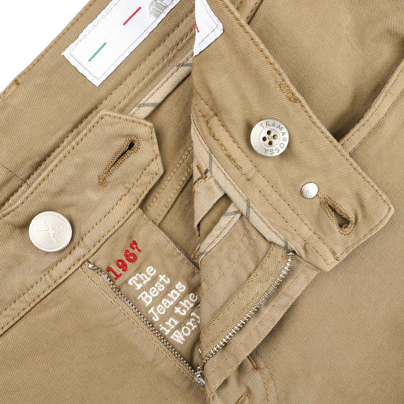 A close-up of Tramarossa's Desert Beige Super Stretch Michelangelo Jeans highlights the button, zipper, and labels with "1967" and "The Best Jeans in the World," crafted for ultimate comfort.