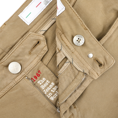 A close-up of Tramarossa's Desert Beige Super Stretch Michelangelo Jeans highlights the button, zipper, and labels with "1967" and "The Best Jeans in the World," crafted for ultimate comfort.