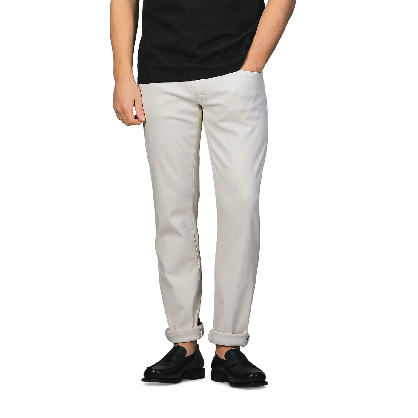 A person wearing a black shirt, Tramarossa Off White Super Stretch Michelangelo Jeans, and black shoes stands against a plain background.