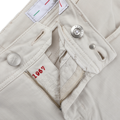 Tramarossa's Off White Super Stretch Michelangelo Jeans feature a cream tone with an unzipped fly, metal button, red "1967" text inside, and an Italian flag detail on the inner waistband near a buttonhole for style.