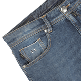 Close-up image of Washed Blue Loro Piana Cotton Michelangelo Jeans from Tramarossa, featuring a small front pocket with visible stitching, button detail, and a label inside the pocket with the initials "LF." The comfort stretch denim ensures a perfect blend of style and flexibility.