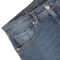 Close-up image of Washed Blue Loro Piana Cotton Michelangelo Jeans from Tramarossa, featuring a small front pocket with visible stitching, button detail, and a label inside the pocket with the initials "LF." The comfort stretch denim ensures a perfect blend of style and flexibility.