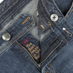 Close-up of the waistband and pocket details of Washed Blue Loro Piana Cotton Michelangelo Jeans by Tramarossa, featuring text that reads "1967 the best jeans in the world," along with visible buttons and stitching.