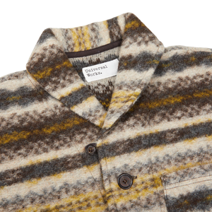 A Universal Works Brown Fair Isle Wool New York Button Cardigan sweater with a yellow, brown, and white stripe made from a boiled merino wool mix.