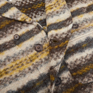 A close up of a Brown Fairisle Wool New York Button Cardigan by Universal Works with buttons and stripes made from boiled merino wool.