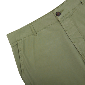 Green Birch Green Cotton Summer Canvas Military Chinos with a button closure on a white background by Universal Works.