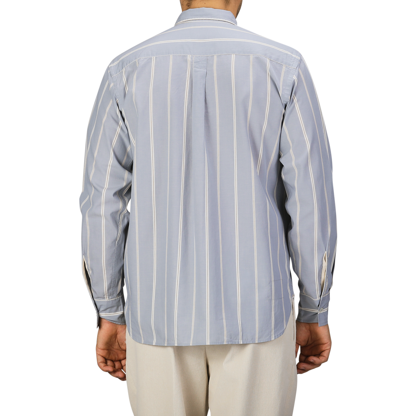 A person wearing a Blue Sydney Striped Cotton Lazy Day Shirt by Universal Works and beige pants, seen from the back.