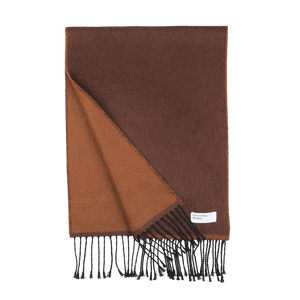 The Brown Double-Sided Acrylic Scarf by Universal Works showcases a meticulously folded design that reveals its rich brown hue and lighter brown underside, complete with fringed edges. A small label near the fringe subtly alludes to its premium acrylic fiber material, epitomizing the craftsmanship of Universal Works.