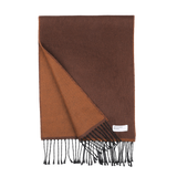 The Brown Double-Sided Acrylic Scarf by Universal Works showcases a meticulously folded design that reveals its rich brown hue and lighter brown underside, complete with fringed edges. A small label near the fringe subtly alludes to its premium acrylic fiber material, epitomizing the craftsmanship of Universal Works.