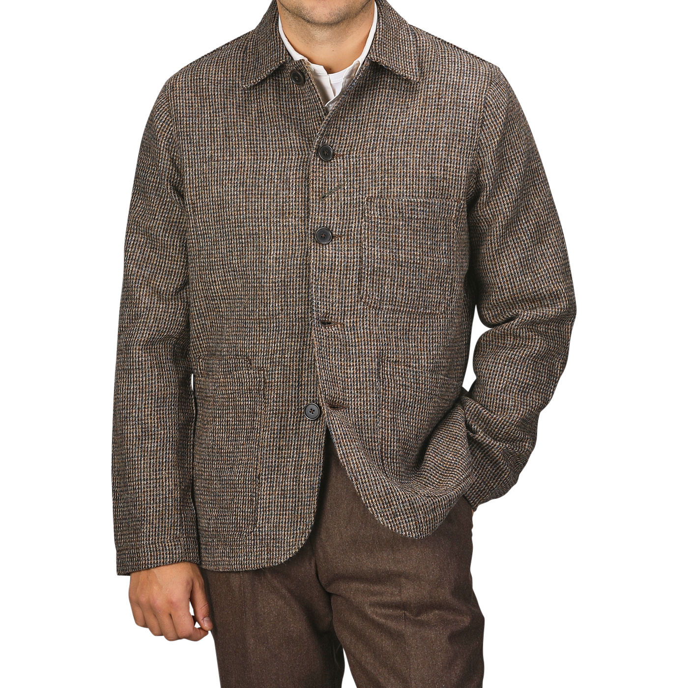 A person wearing a Brown Melange Harris Tweed Bakers C Jacket by Universal Works and brown trousers stands against a plain background. Their right hand is in their pocket, and their head is not visible in the frame.