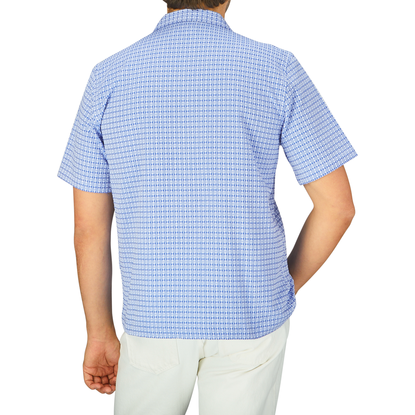 The back view of a man wearing a Light Blue Cotton Camp Collar Road Shirt by Universal Works.
