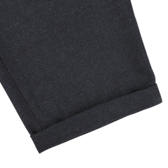 Close-up image of a navy blue fabric with a rolled hem, likely part of Universal Works Navy Blue Birdseye Tweed Military Chinos.