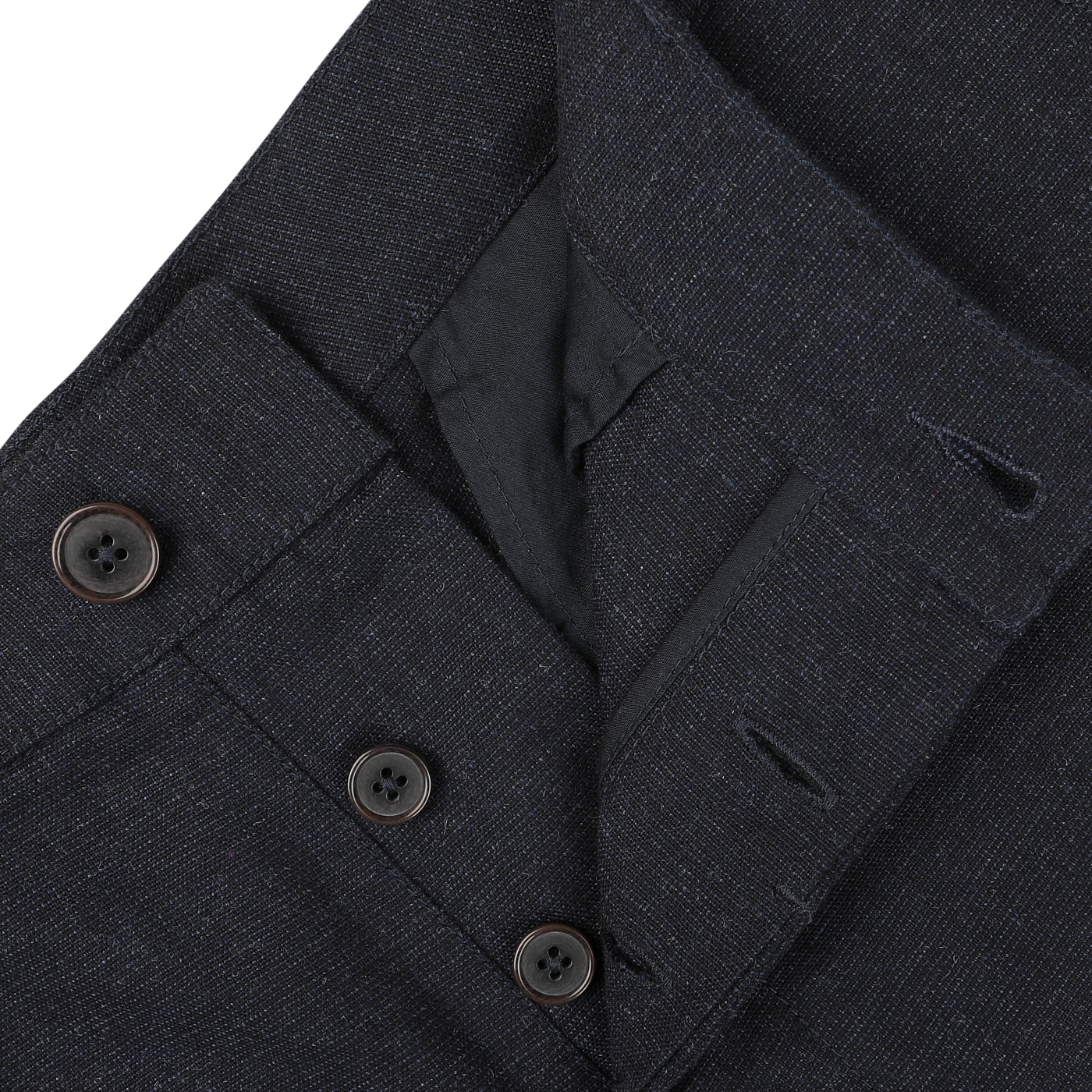 Close-up of navy blue Birdseye tweed Military Chinos from Universal Works, featuring a buttoned fly and part of the waist area. The fabric, made of upcycled wool tweed, is textured, with visible buttons and buttonholes.