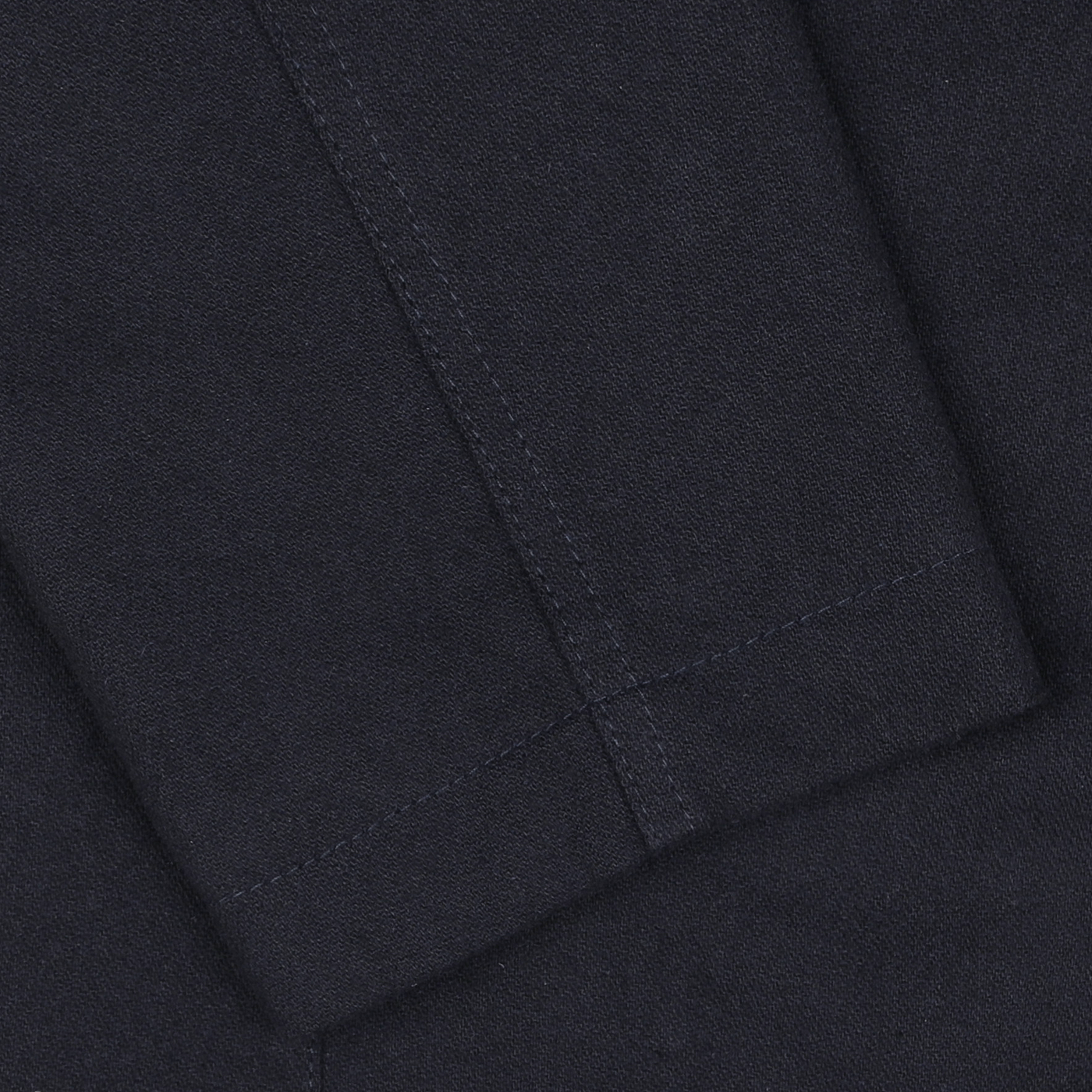 Close-up view of the Universal Works Navy Blue Upcycled Tweed 2 Button Jacket fabric with detailed stitching visible, made from upcycled wool tweed.