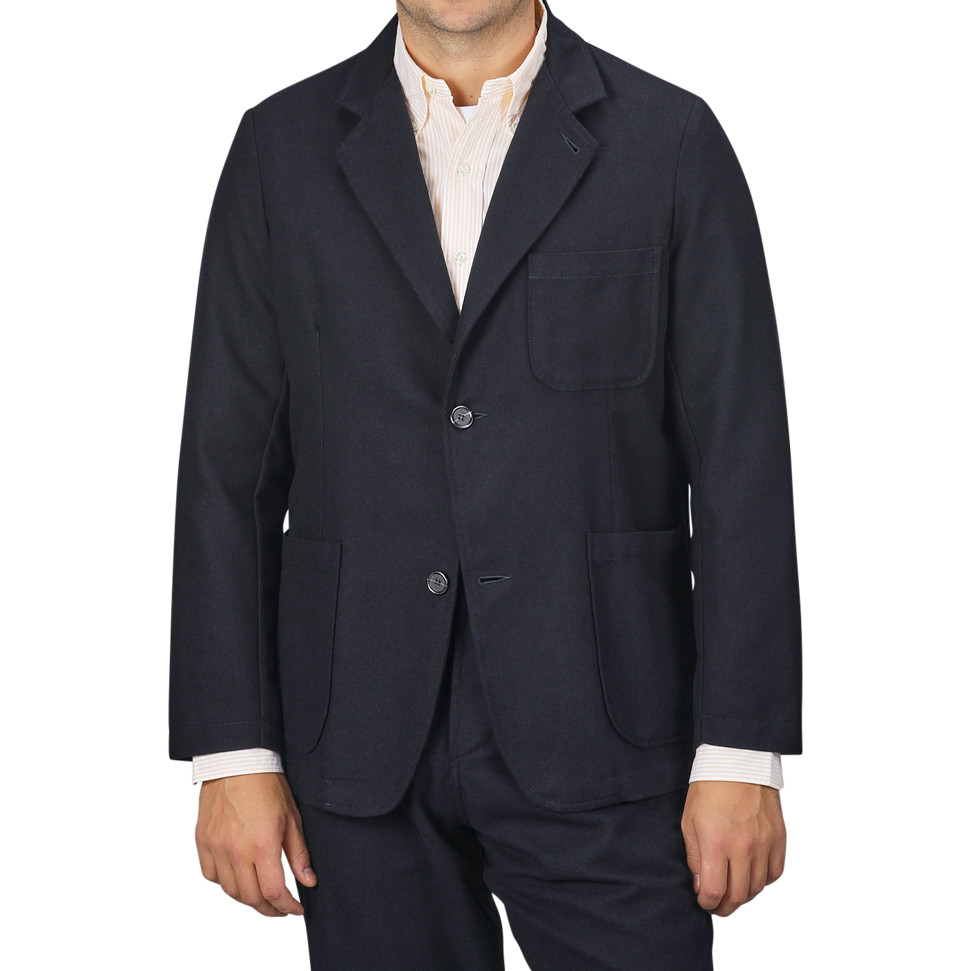 A man wearing the Universal Works Navy Blue Upcycled Tweed 2 Button Jacket over a light-colored shirt, standing against a plain gray background. The sleek design features three front pockets and is crafted from upcycled wool tweed, merging modern style with sustainable fashion.