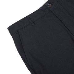 Close-up image of a pair of Navy Blue Upcycled Tweed Military Chinos by Universal Works, showcasing the waistband, button, and pleated front detail.