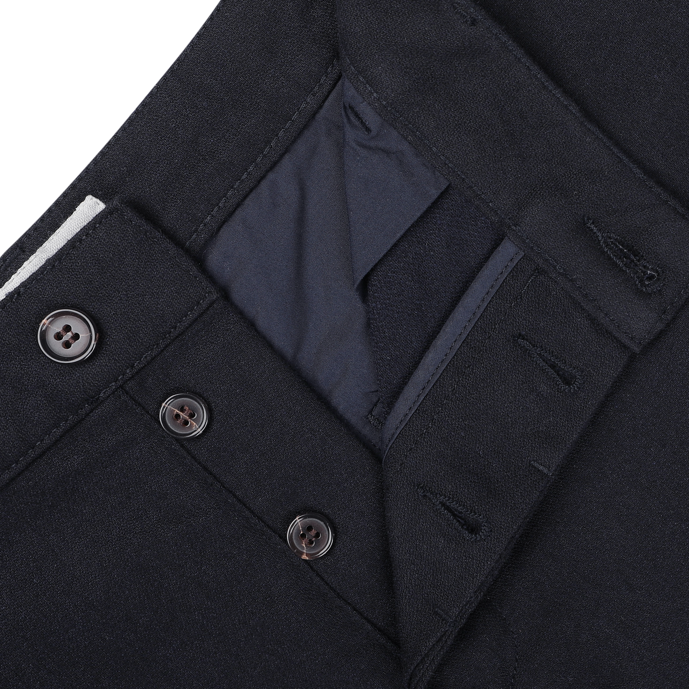 Close-up of Universal Works Navy Blue Upcycled Tweed Military Chinos showing the button fly, waistband with buttons, and an inner pocket detail.