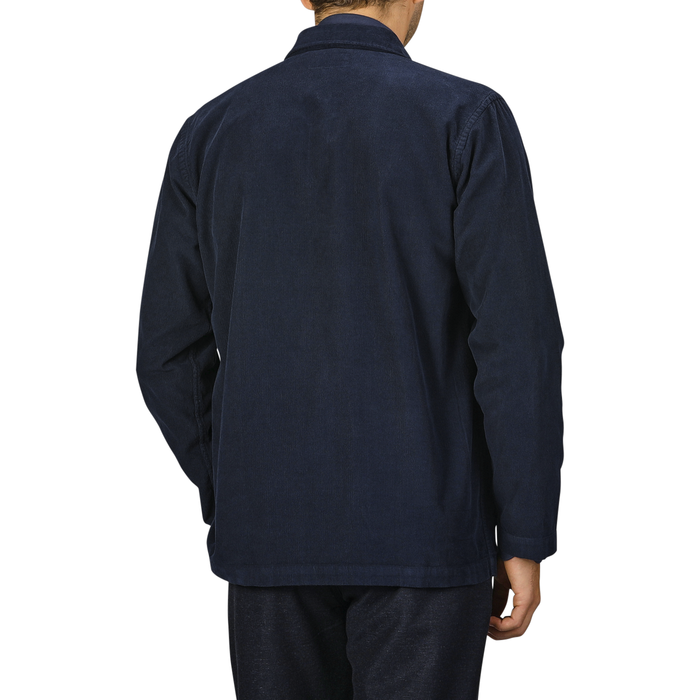 Man wearing a Universal Works Navy Fine Corduroy Bakers Overshirt and matching pants, seen from the back, standing against a plain background.