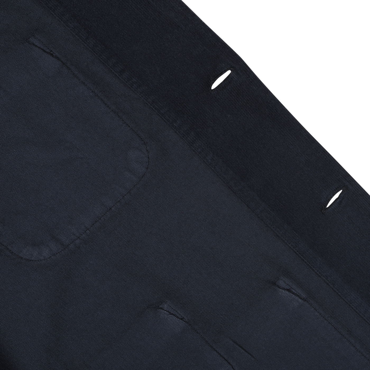 Close-up of the Navy Fine Corduroy Bakers Overshirt by Universal Works, showcasing its dark blue cotton corduroy fabric with pockets and buttonholes, suggesting it is part of a garment like a shirt jacket or coat.