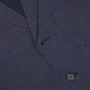 A close up of a navy blue Universal Works Navy Puppytooth Linen Cotton 3-Button Jacket.