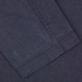 A close-up of a navy blue, checkered Universal Works Navy Puppytooth Linen Cotton 3-Button Jacket.