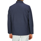 The back view of a man wearing a navy blue, Universal Works Navy Puppytooth Linen Cotton 3-Button Jacket.