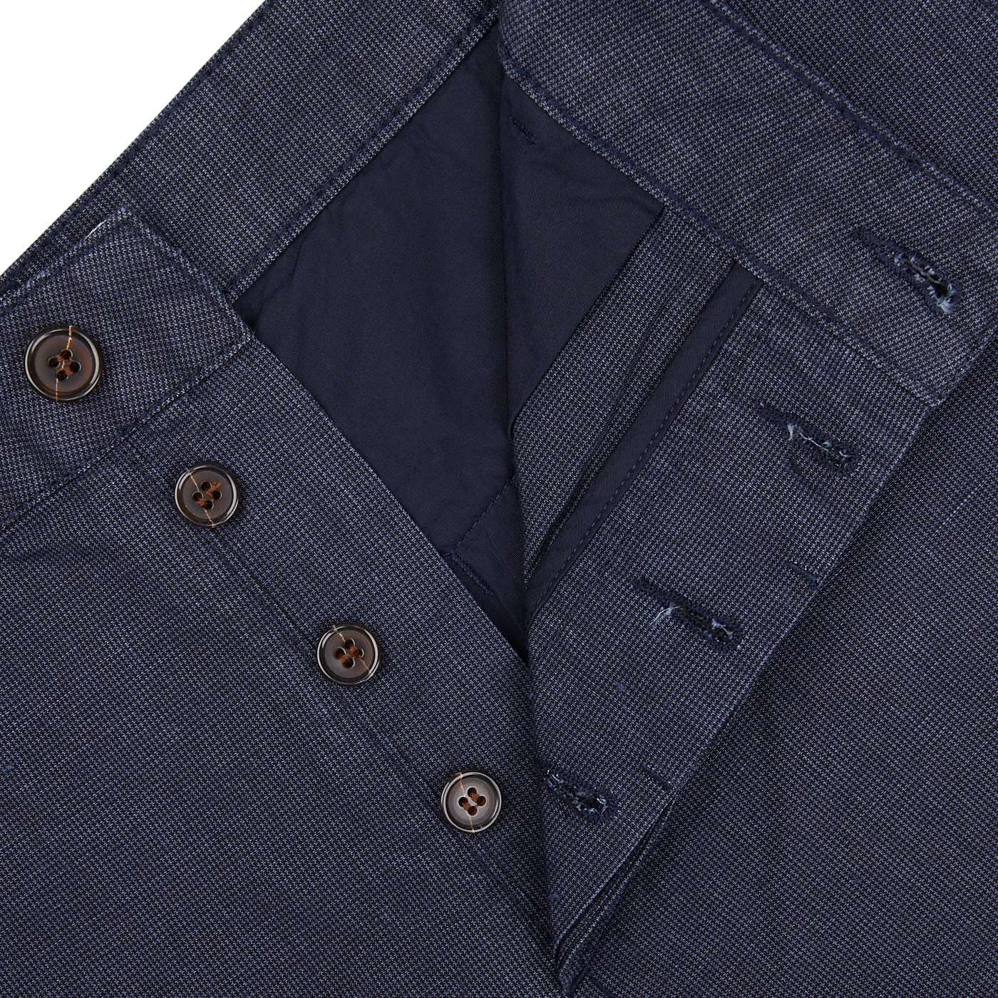 Close-up of a navy blue cotton suit jacket with buttons. could be replaced with Close-up of a Navy Puppytooth Linen Mix Military Chinos by Universal Works.