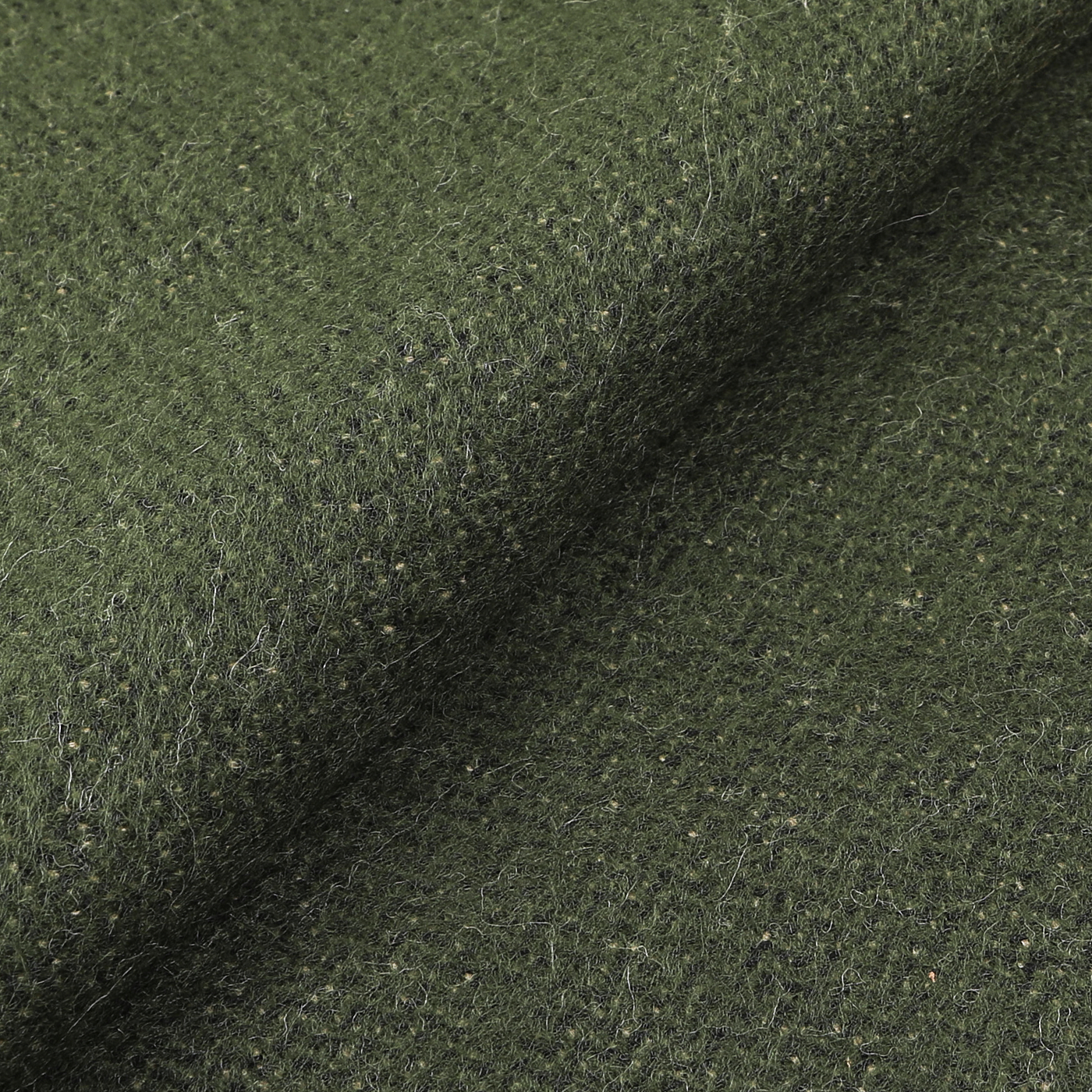 Close-up of a textured green woolen fabric with visible fibers and a slightly rough surface, perfect for the Grass Beige Double Sided Acrylic Scarf made in Italy by Universal Works.