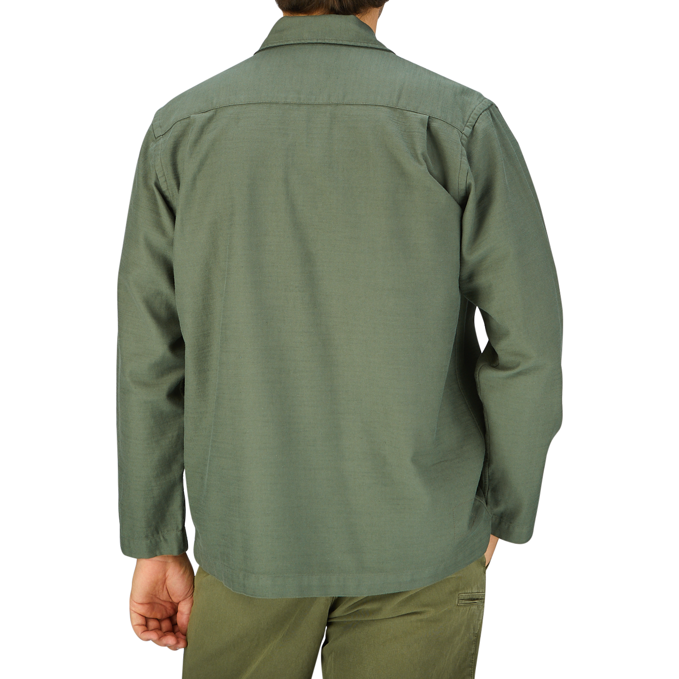A man wearing a grey Universal Works Olive Green Cotton Sateen Dockside jacket seen from the back.