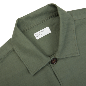 Olive Green Cotton Sateen Dockside Jacket by Universal Works with a clothing label.