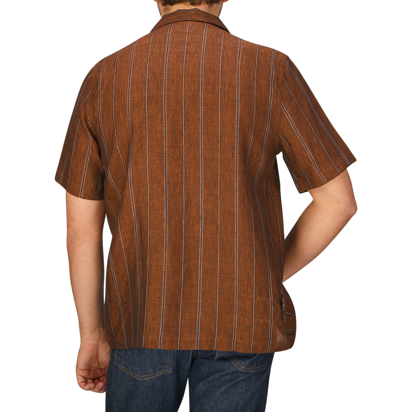 The back view of a man wearing a Universal Works Rust Brown Striped Linen Road Camp Collar Shirt.