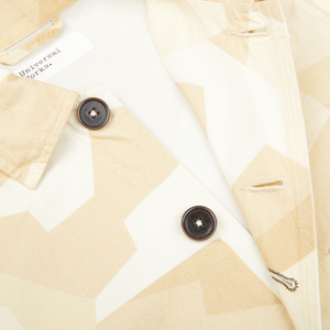 An image of a Sand Beige Camo Cotton Bakers C Jacket with buttons from Universal Works.