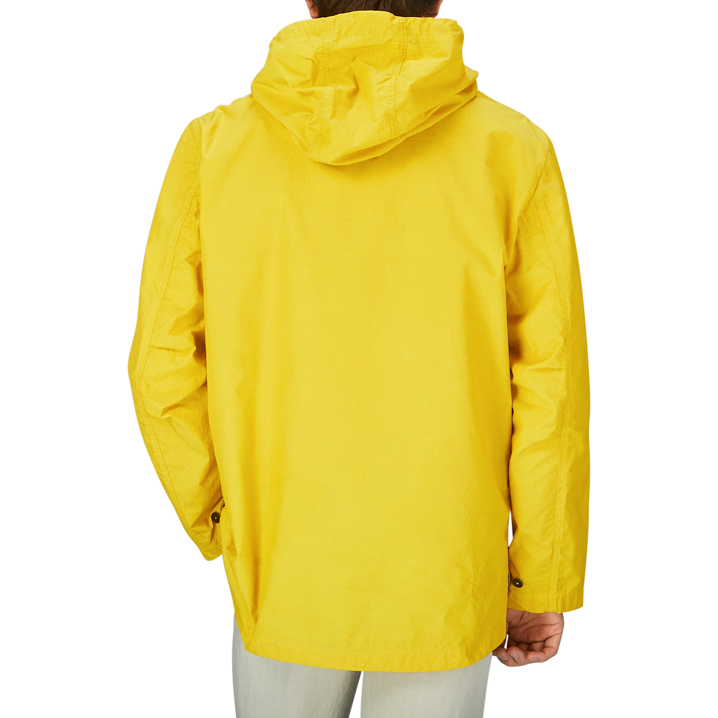 The back view of a man wearing a water-resistant Universal Works Yellow Cotton Ripstop Stanedge Jacket.